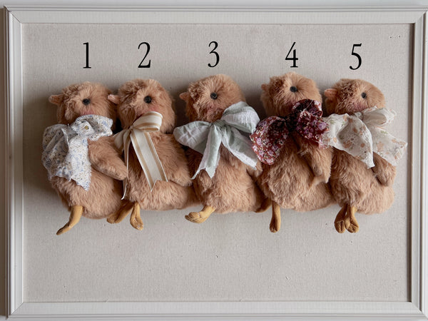 faux fur chick dolls with scarf on a light background