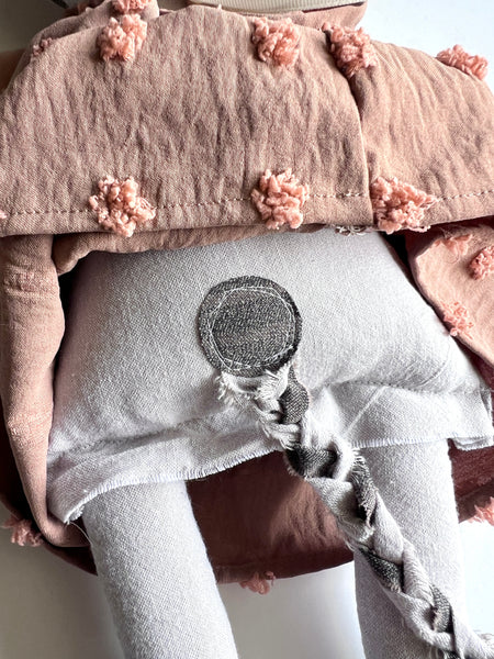 Back detail of cat doll.