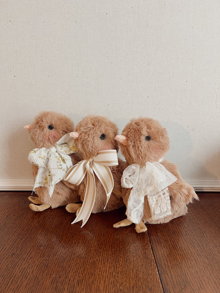 faux fur chick dolls with scarf on a light background