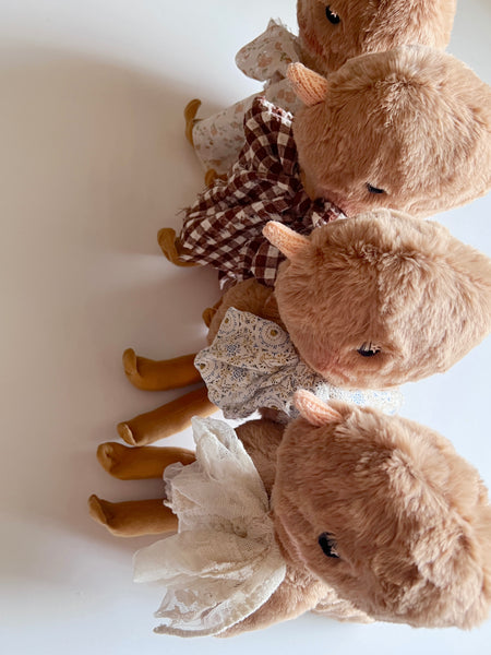 faux fur chick dolls with scarves on a light background