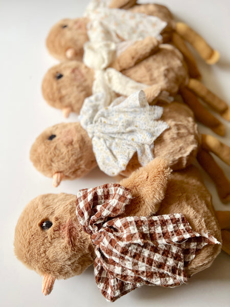 faux fur chick dolls with scarves on a light background
