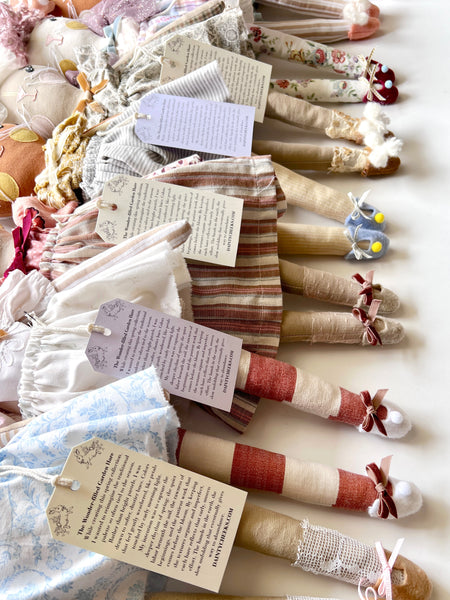 row of handmade rabbit dolls focusing on the leg and shoe details