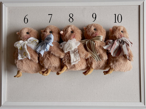 faux fur chick dolls with scarf on a light background