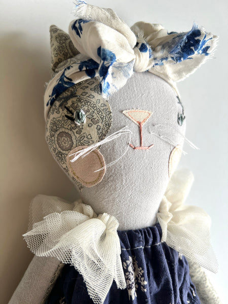 Close-up of cat doll face.