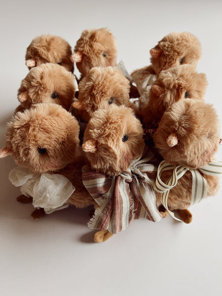 faux fur chick dolls with scarf on a light background