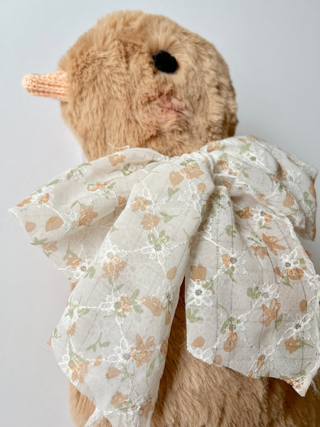 faux fur chick dolls with scarf on a light background