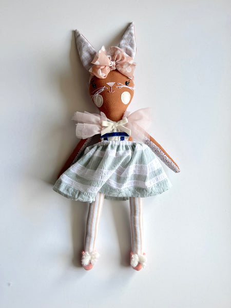 bespoke bunny doll with a dress on a light gray background