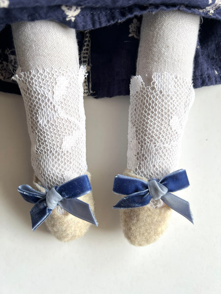 doll leg detail  with stockings and felt shoe.