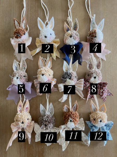 Decorative bunny ornaments with numbers on a wooden background