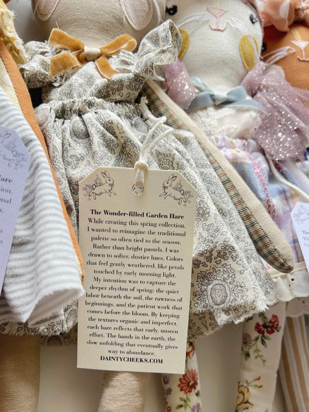 doll with a hangtag on a wooden surface